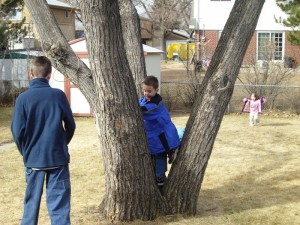 Trying out the tree (Emma in the background, joining them)