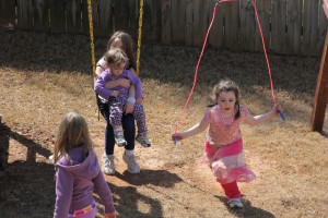 Sisters' outside playtime.  I love how Emma helped Abby swing by holding her on her lap.  :)